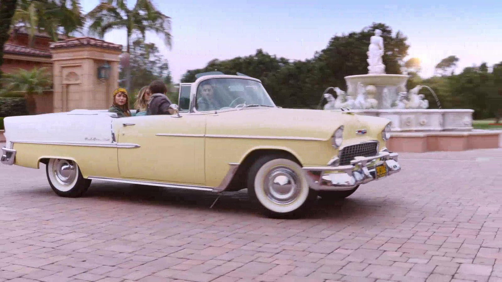 a group of people in a convertible car